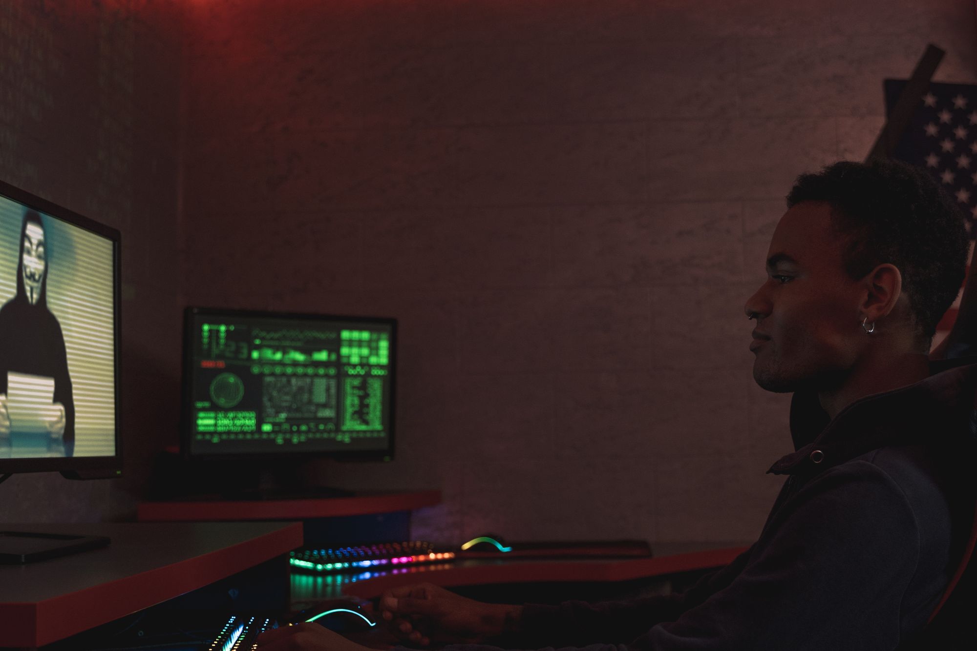 Security analyst monitoring systems in a dark room